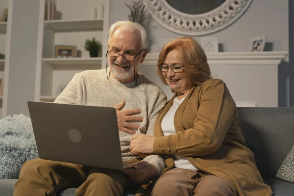  two people using a laptop