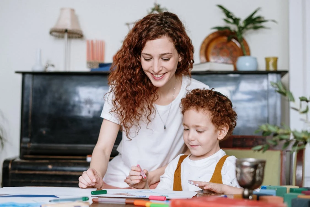 a mother coloring with their child