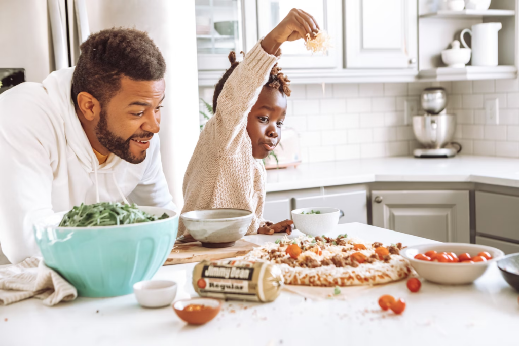  a father helping their child cook