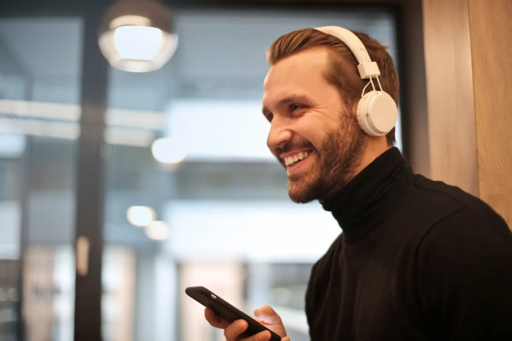 a person smiling and listening to music