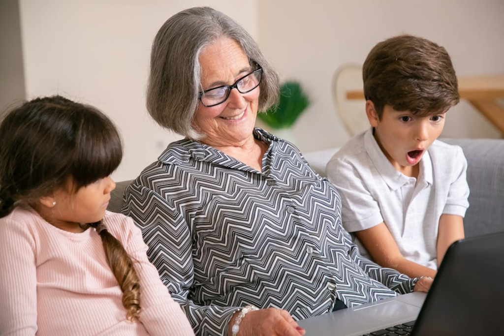 a person looking at a laptop with children