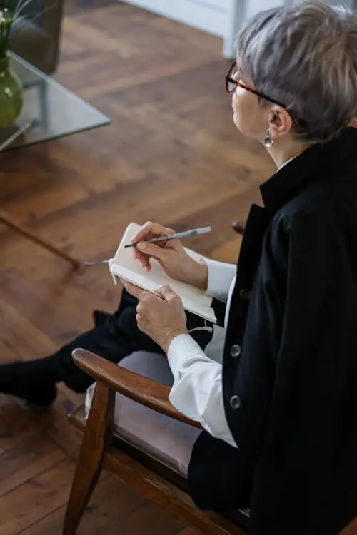 A professional therapist taking notes during a counseling session.