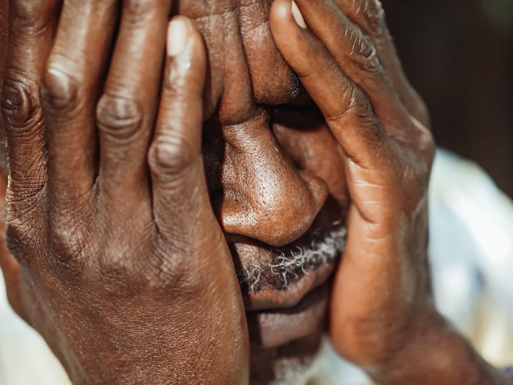A person covering their face