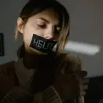 A person with tape on their mouth